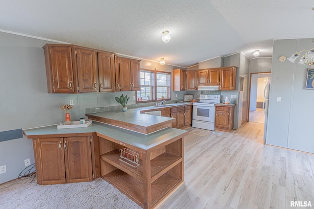 408 W Kirkwood St, Odin, IL 62870 - kitchen with white appliances, under cabinet range hood, brown cabinets, lofted ceiling, and a peninsula