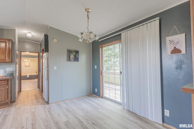 408 W Kirkwood St, Odin, IL 62870 - unfurnished dining area with a textured ceiling, light wood-type flooring, a chandelier, and ornamental molding