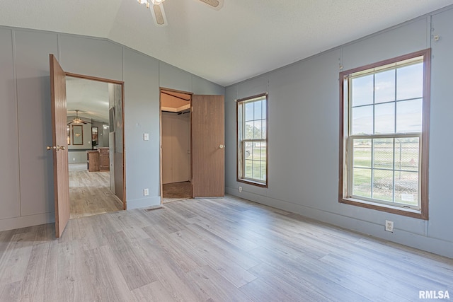 408 W Kirkwood St, Odin, IL 62870 - unfurnished bedroom with lofted ceiling, light wood-type flooring, a ceiling fan, and a closet