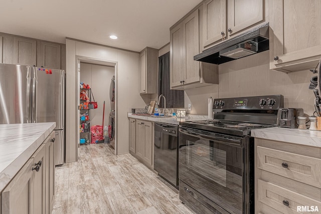 kitchen with sink, light hardwood / wood-style flooring, and black appliances