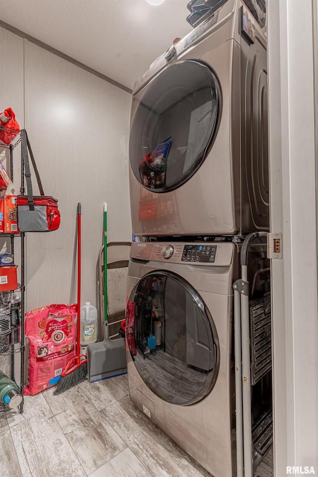 washroom with stacked washer / drying machine