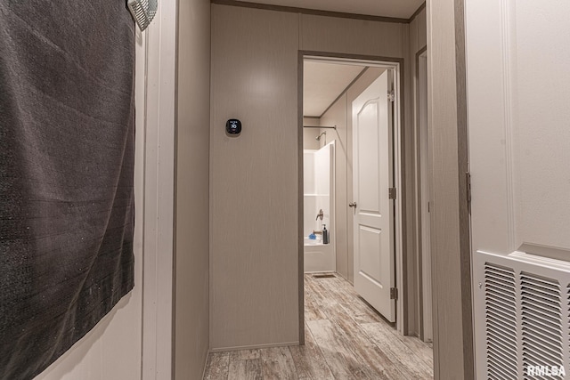 hallway with light hardwood / wood-style floors