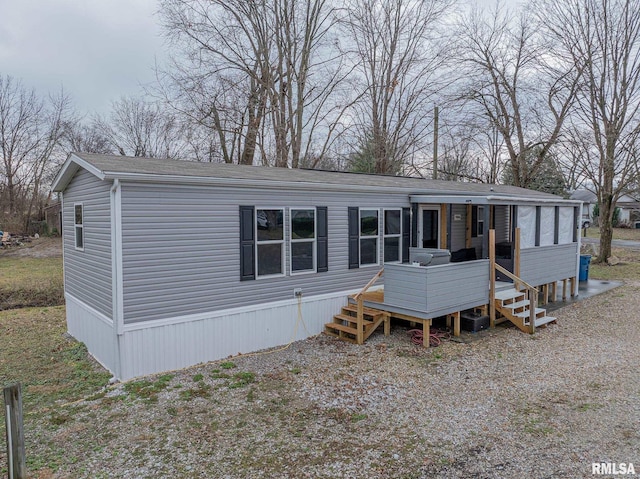 back of house featuring a sunroom