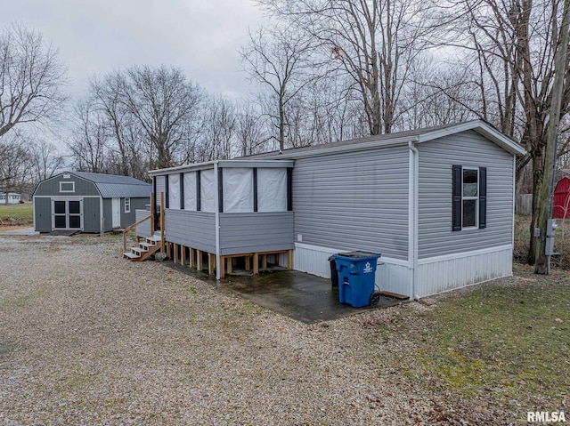 view of front of property with a storage shed