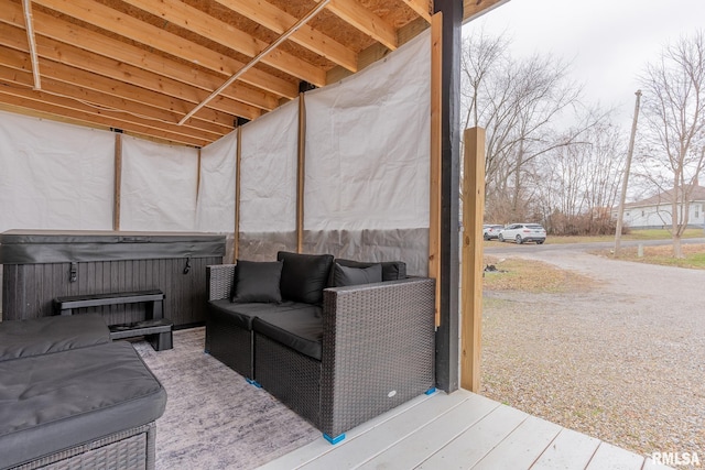 wooden terrace featuring an outdoor hangout area and a hot tub