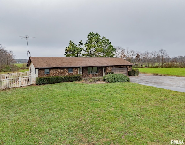 single story home with a front yard and a garage