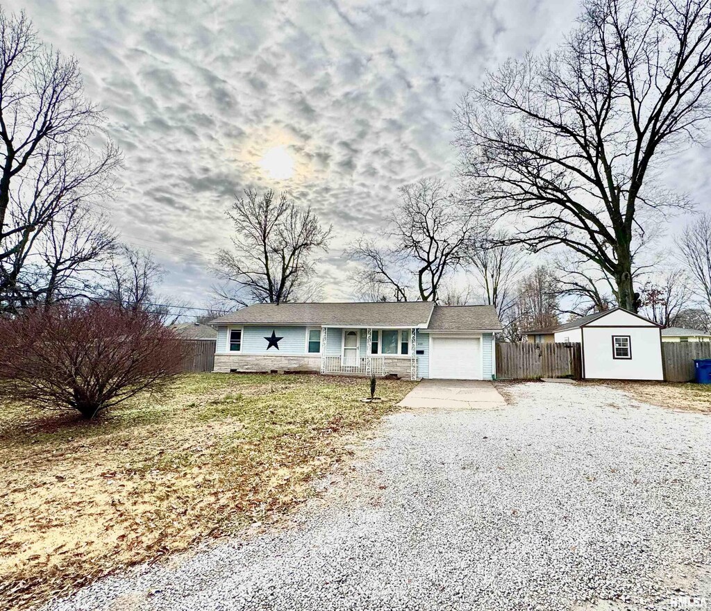 409 Orange, Mount Vernon, IL 62864 - single story home featuring fence, driveway, a porch, an attached garage, and stone siding
