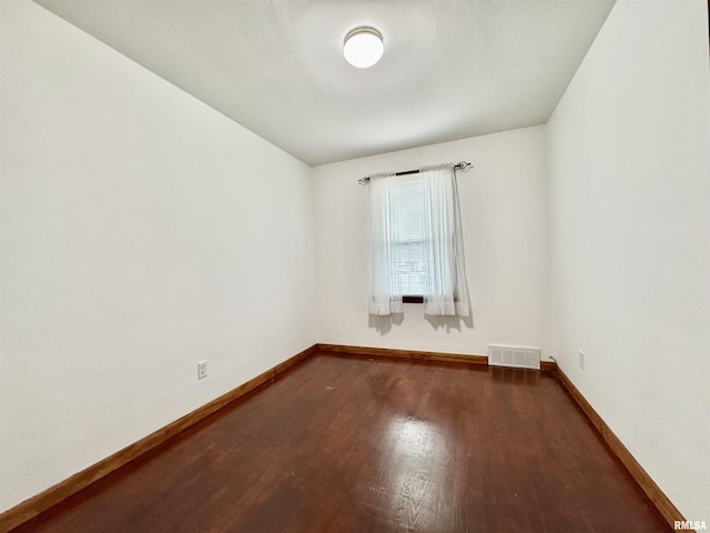 spare room with dark hardwood / wood-style flooring