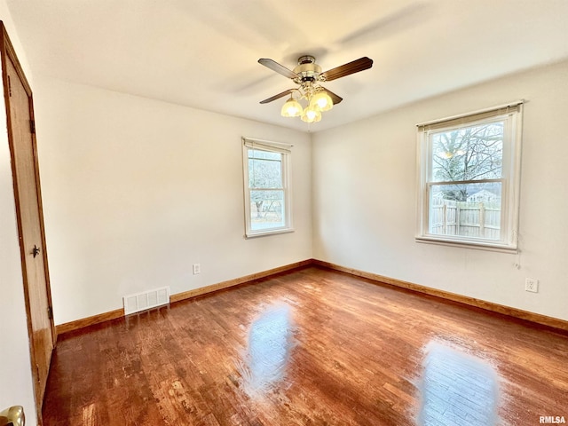 unfurnished room with ceiling fan and dark wood-type flooring