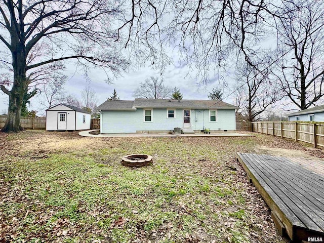 back of house with a patio area, a shed, and an outdoor fire pit