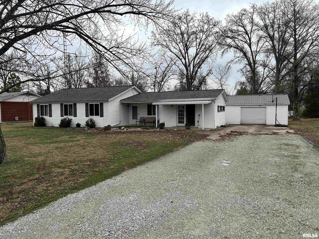 view of front facade featuring a front yard, a porch, and a garage