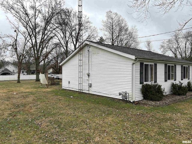 view of side of property with a lawn