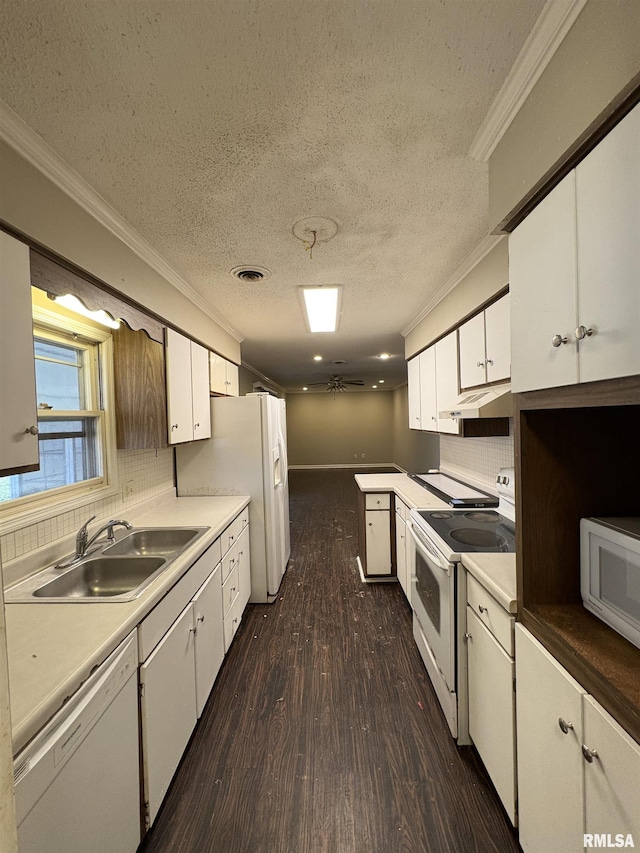 kitchen featuring sink, a textured ceiling, white appliances, decorative backsplash, and white cabinets