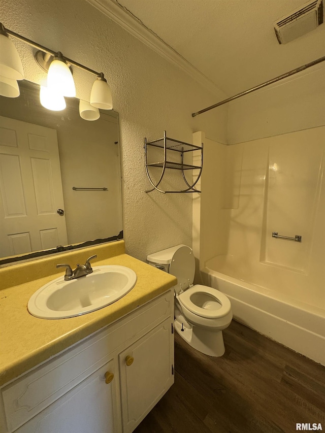 full bathroom featuring shower / bath combination, vanity, crown molding, wood-type flooring, and toilet