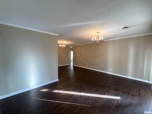 empty room with a chandelier, a textured ceiling, dark wood-type flooring, and ornamental molding