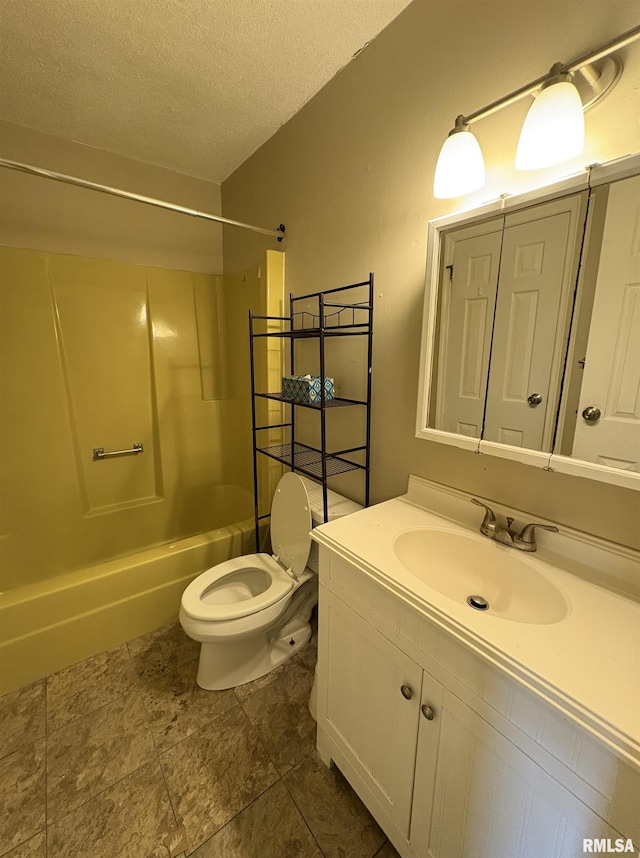 full bathroom with vanity, toilet, a textured ceiling, and bathing tub / shower combination