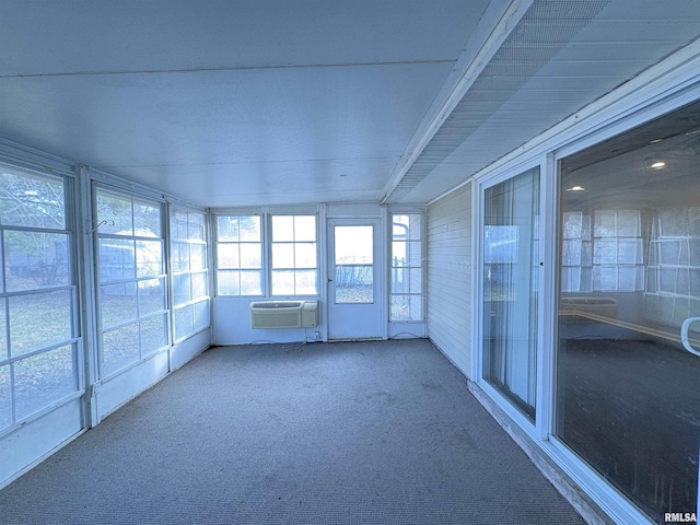 unfurnished sunroom featuring a wall unit AC