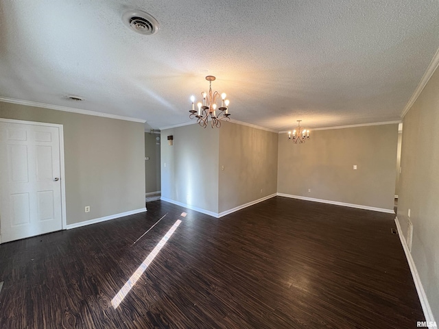 empty room featuring a textured ceiling, dark wood-type flooring, crown molding, and an inviting chandelier