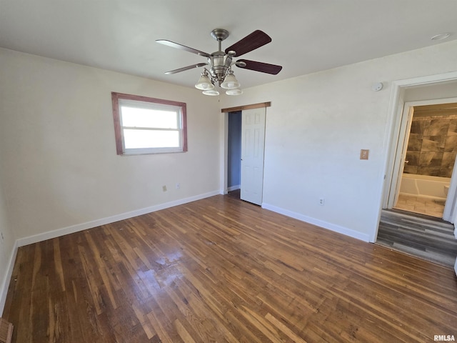 empty room featuring dark hardwood / wood-style floors and ceiling fan