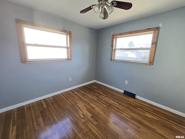 unfurnished room with dark hardwood / wood-style flooring and ceiling fan