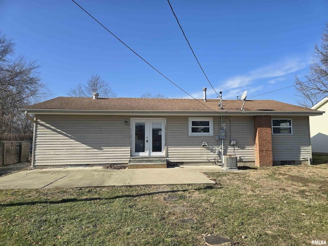 back of house with cooling unit, a patio area, a yard, and french doors