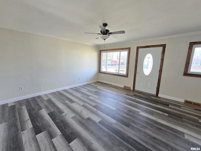 foyer with dark hardwood / wood-style floors, ceiling fan, and crown molding