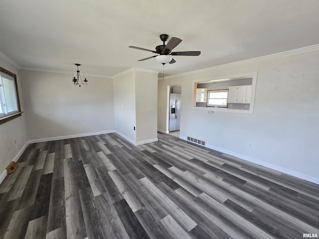 unfurnished room with crown molding, ceiling fan with notable chandelier, and dark hardwood / wood-style floors