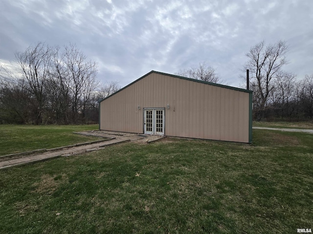 view of outdoor structure featuring french doors and a lawn