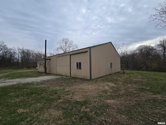 view of outbuilding with a lawn