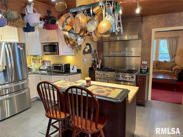 kitchen with white cabinetry, a kitchen island, and stainless steel appliances