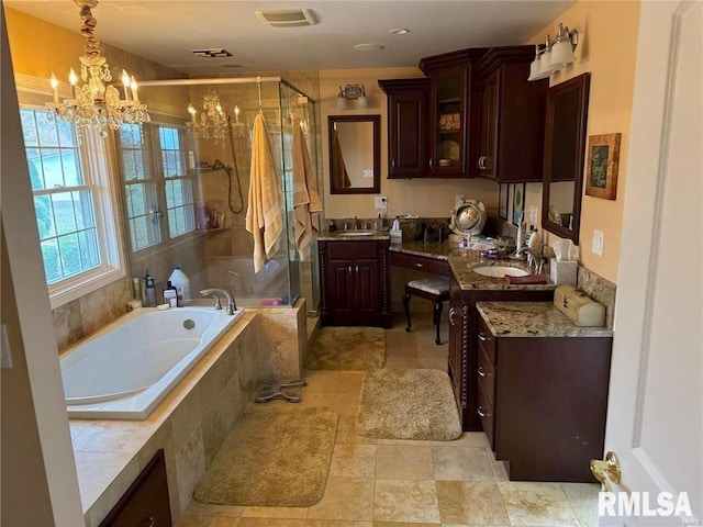 bathroom featuring vanity, shower with separate bathtub, and a notable chandelier