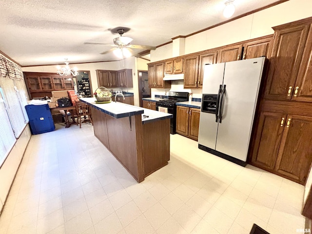 kitchen with ornamental molding, an island with sink, refrigerator with ice dispenser, gas stove, and a breakfast bar area