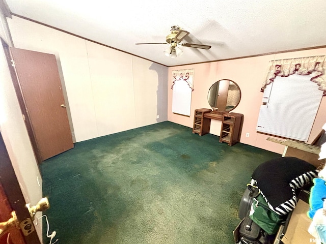 interior space with crown molding, ceiling fan, dark carpet, and a textured ceiling