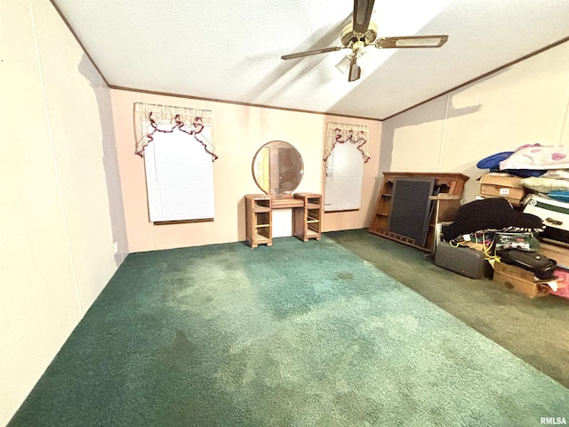 interior space with ceiling fan, carpet, a textured ceiling, and ornamental molding