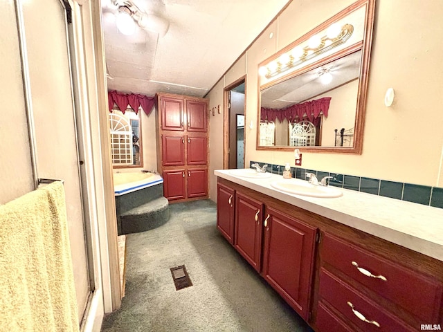 bathroom with vanity, lofted ceiling, and shower with separate bathtub