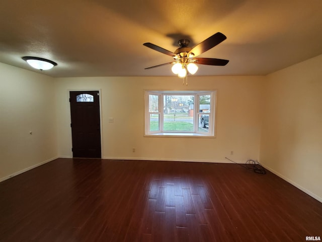 interior space with dark hardwood / wood-style flooring and ceiling fan