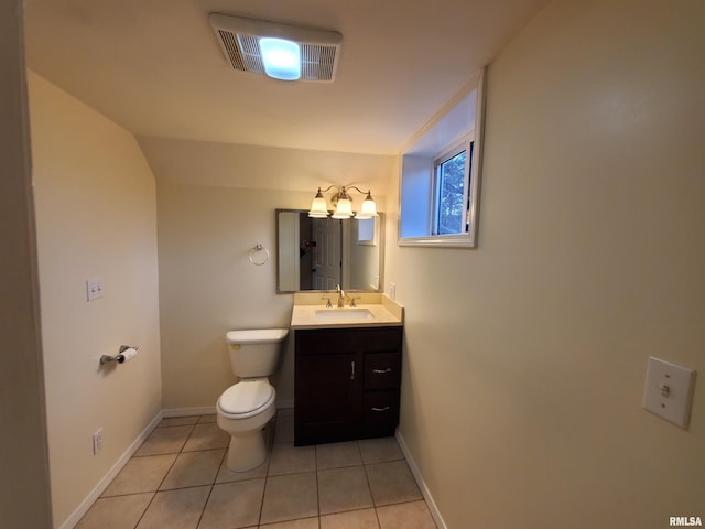 bathroom with tile patterned flooring, vanity, and toilet