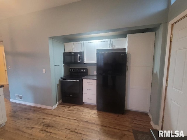 kitchen featuring black appliances, light hardwood / wood-style floors, and white cabinets