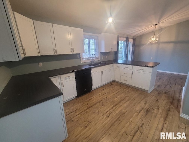 kitchen featuring white cabinetry, sink, black dishwasher, kitchen peninsula, and decorative light fixtures