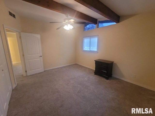 carpeted spare room with ceiling fan and lofted ceiling with beams