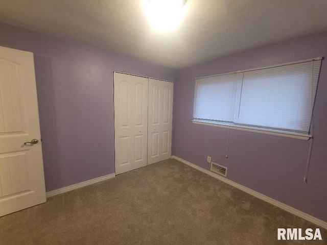 unfurnished bedroom featuring a closet and carpet floors