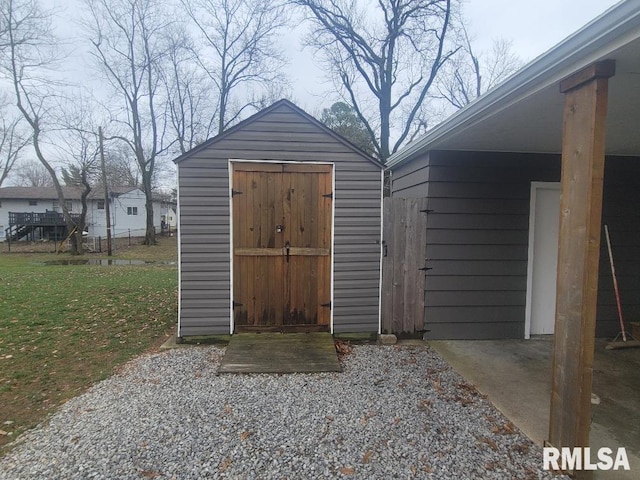 view of outbuilding featuring a yard