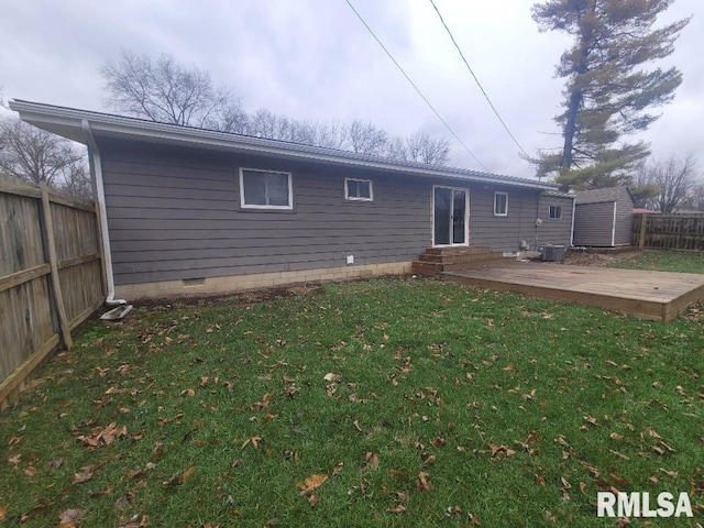 back of property with a deck, central AC unit, and a lawn