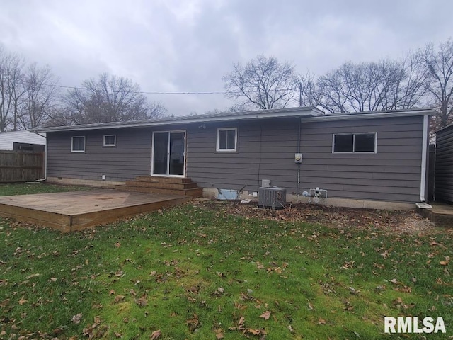 rear view of house featuring a yard, a deck, and central air condition unit