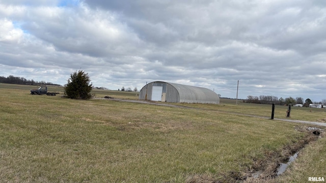 view of yard featuring a rural view and an outbuilding