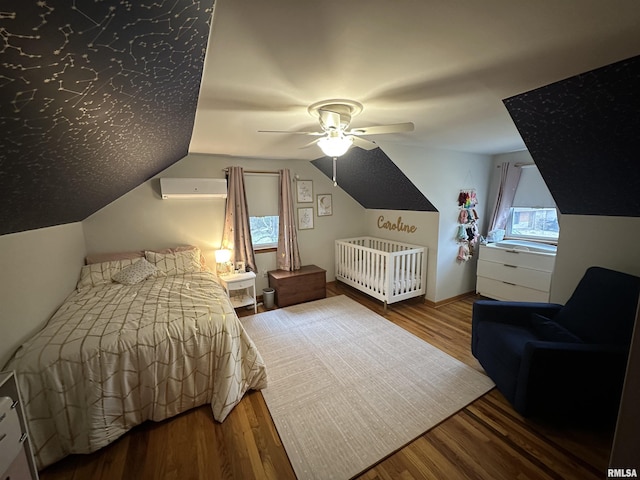 bedroom with hardwood / wood-style floors, ceiling fan, a wall mounted air conditioner, and lofted ceiling