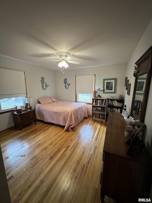 bedroom with light wood-type flooring and ceiling fan