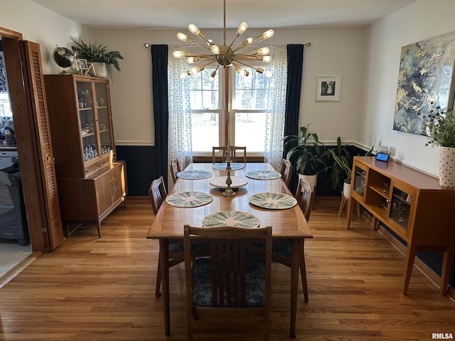 dining room with a chandelier and hardwood / wood-style floors