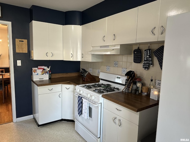 kitchen with white cabinets, white appliances, backsplash, and exhaust hood