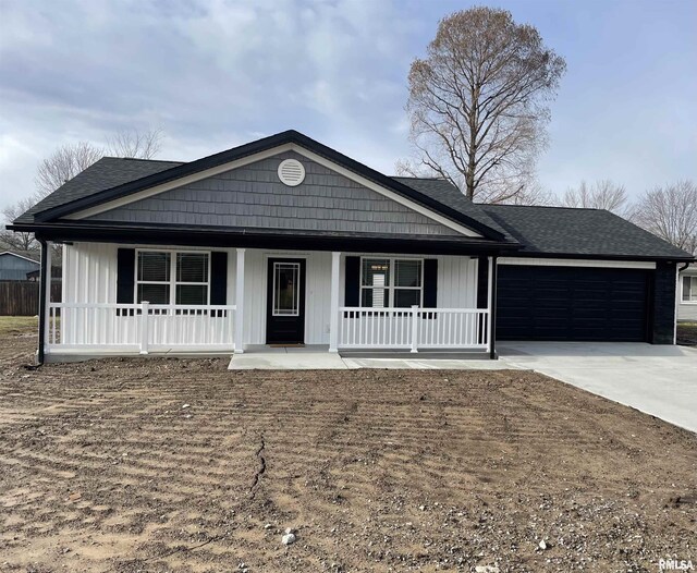 view of front of home with covered porch and a garage